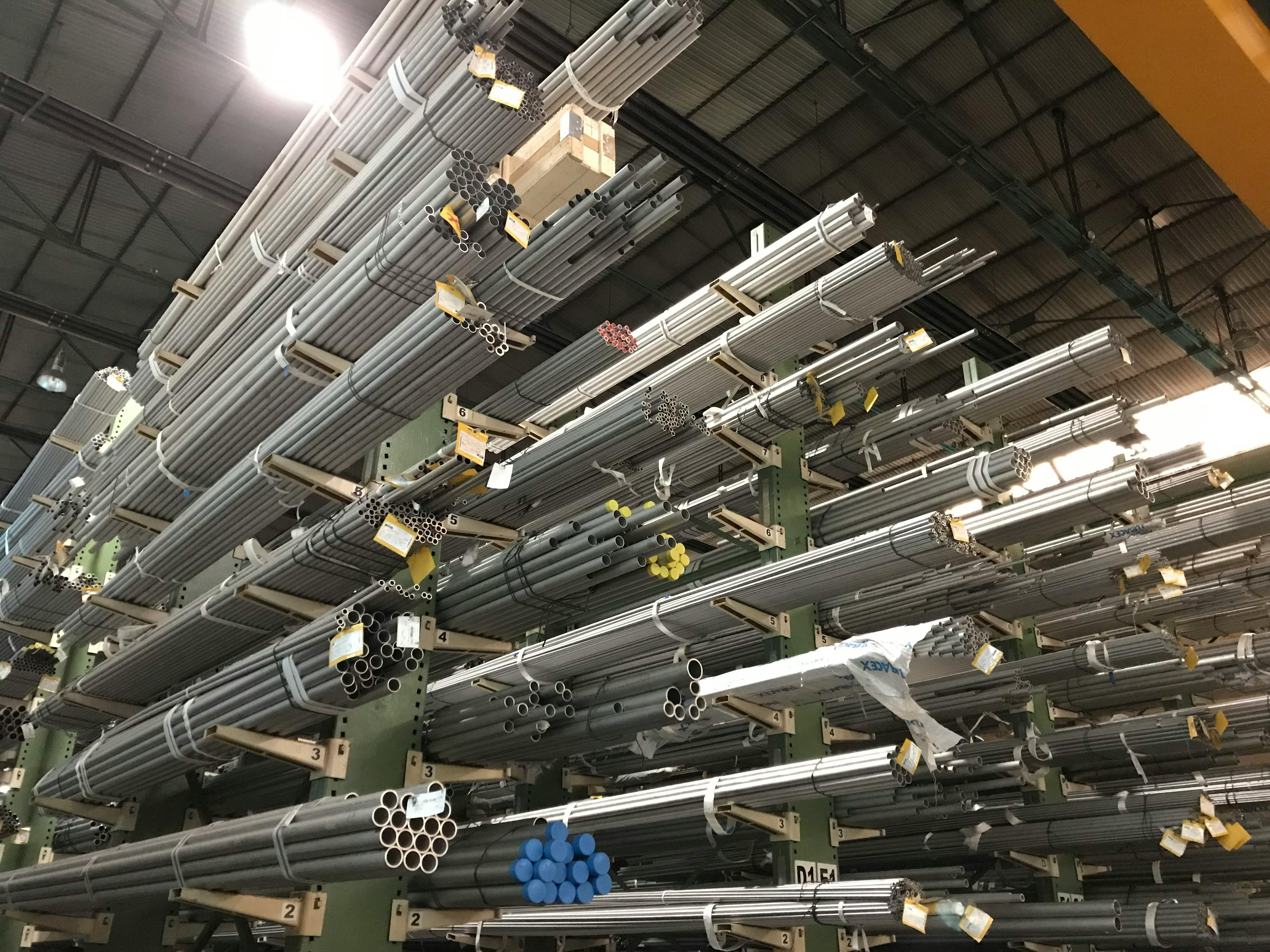 Steel pipe stockyard warehouse with organised inventory racks for IBR seamless and ERW pipes